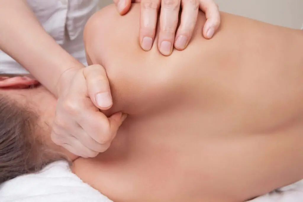 A massage therapist applying cupping therapy on a client’s back to improve circulation and reduce muscle soreness.